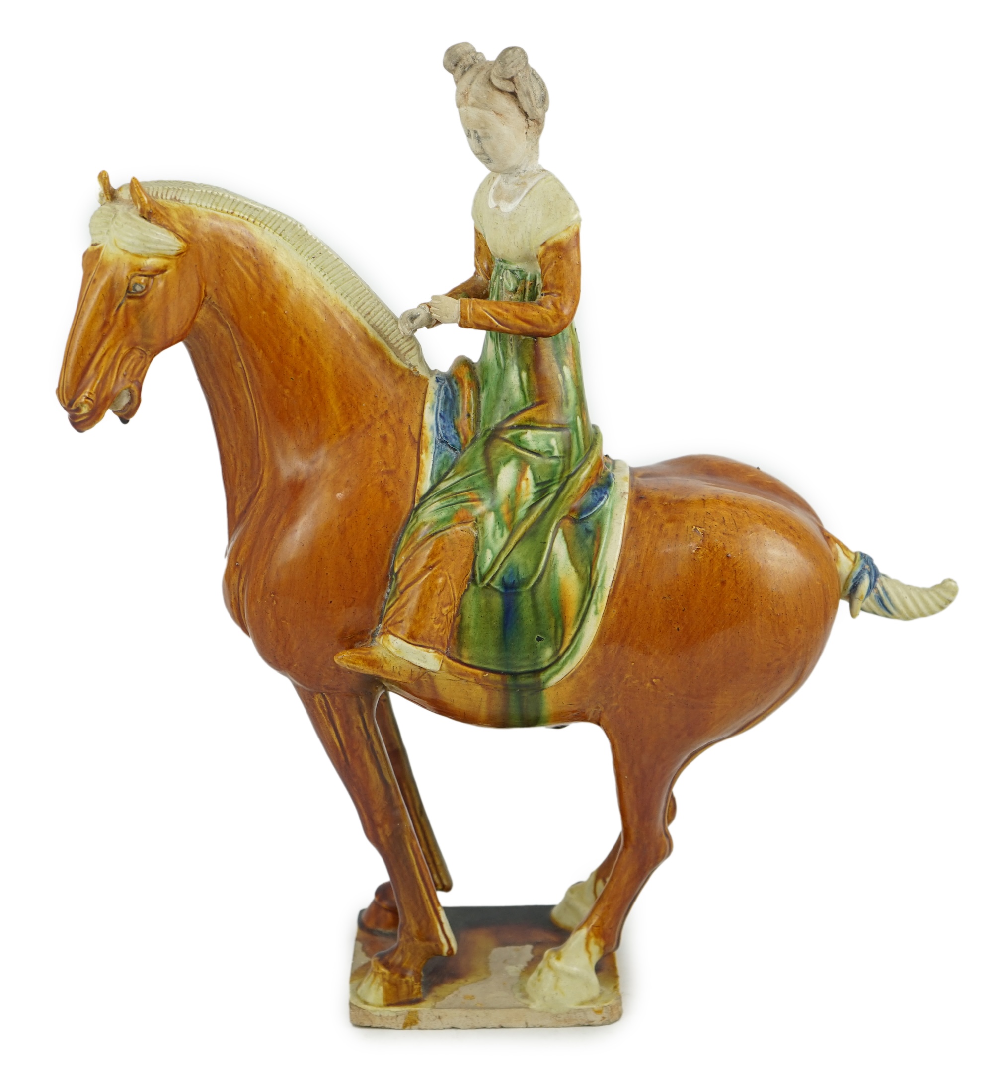 A Chinese sancai glazed group of a horse and female rider, Tang or later